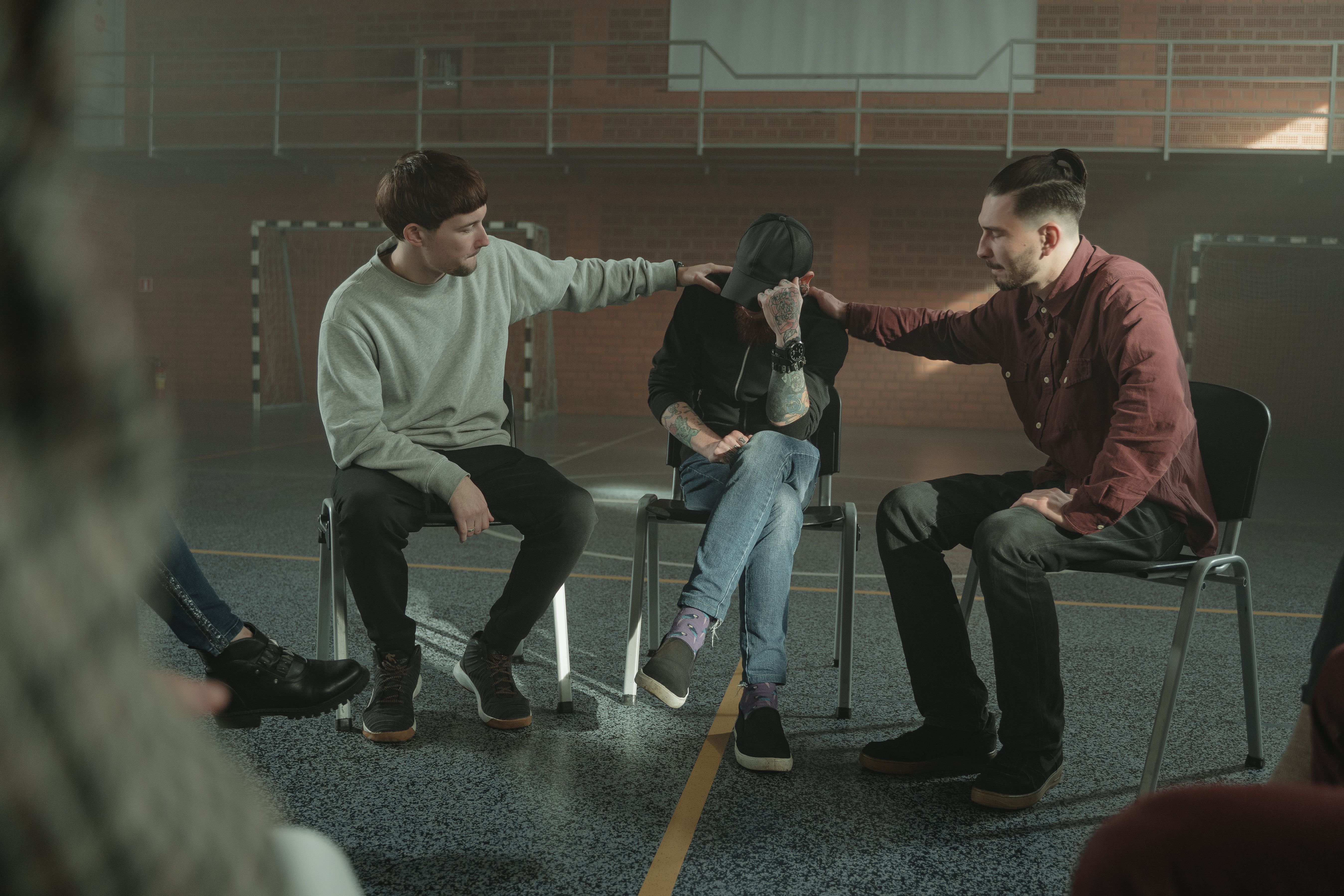 Men supporting one another in a group session